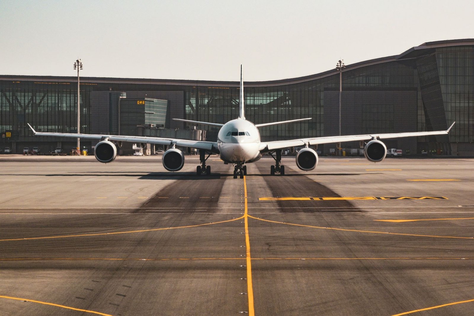 Wide-body airliner taxiing toward the terminal in daylight